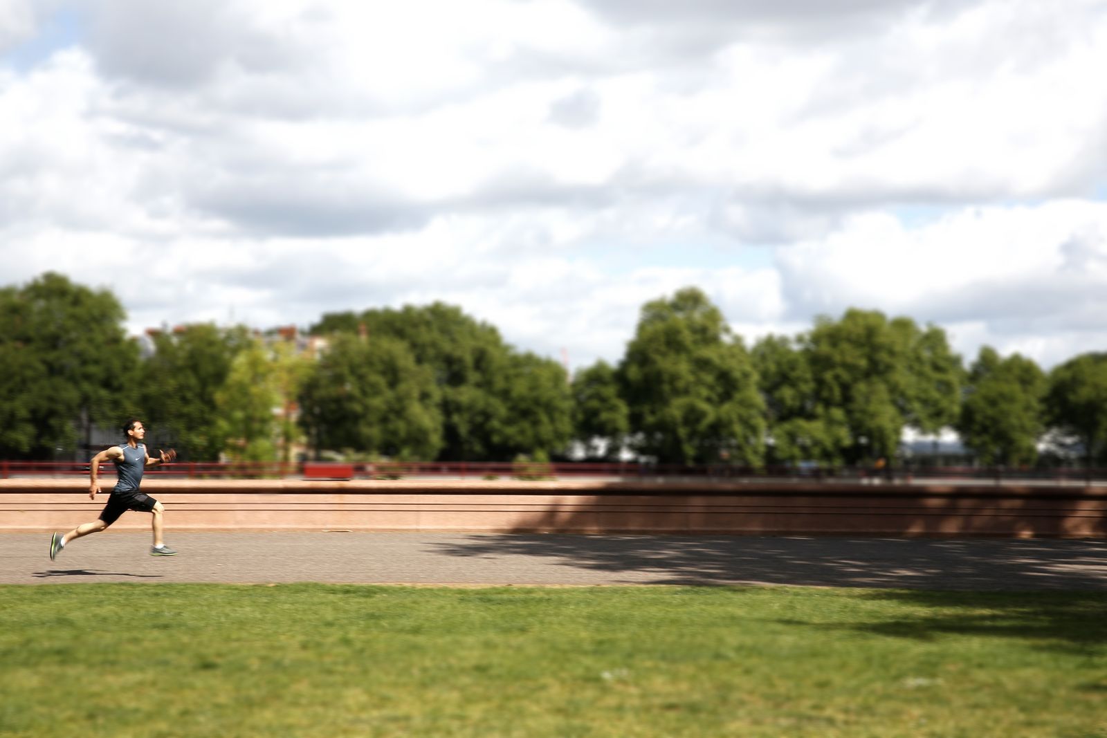 Roland sprinting by the river in Battersea Park